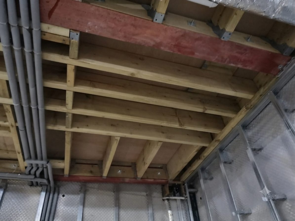 Ceiling void at first fix, with joists, soil pipes and insulated ducting set out before boarding