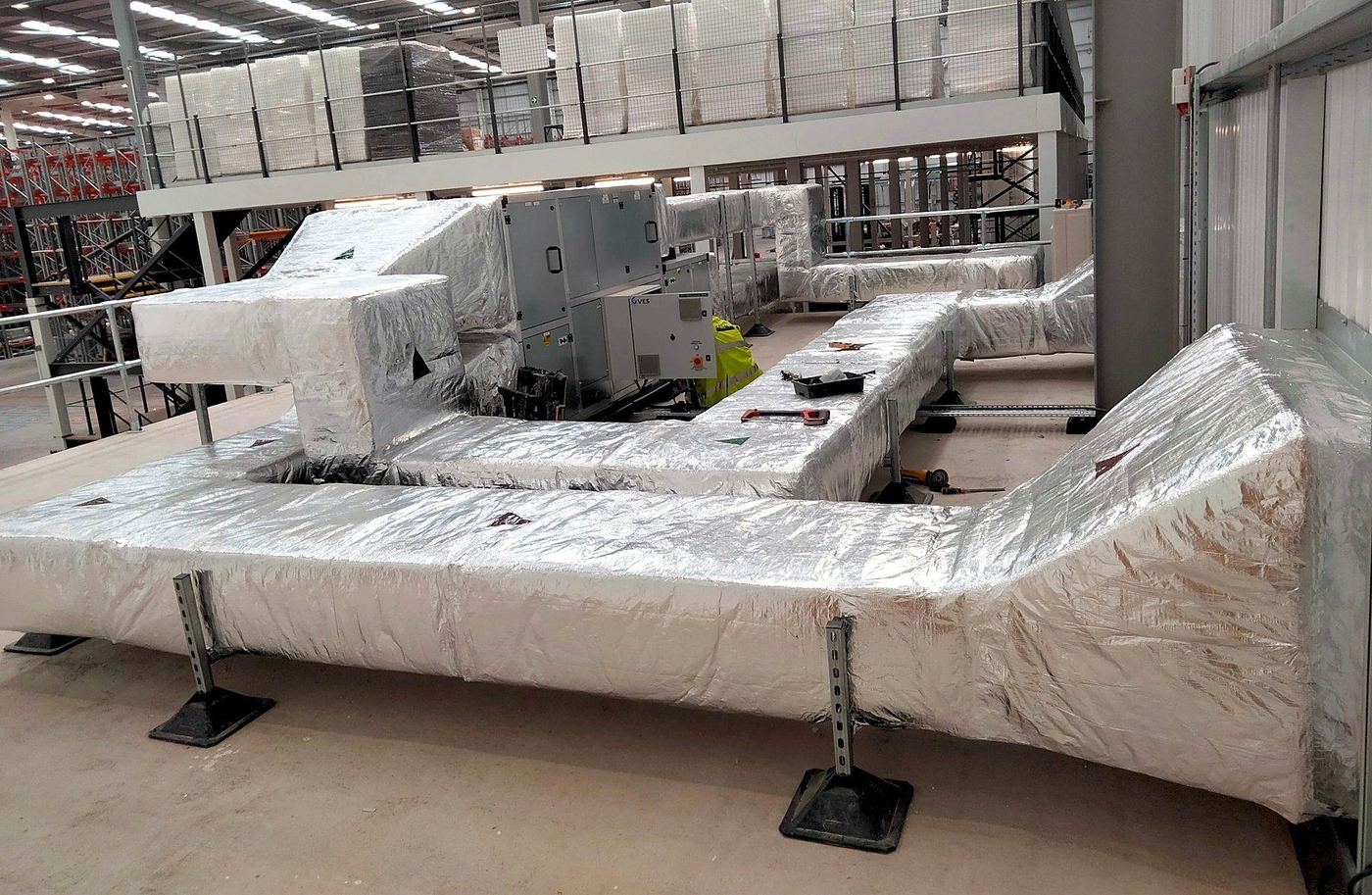 Insulated rectangular ductwork installed by Cavalli Ventilation, run off an air handling unit and carried level along the roof of a commercial unit